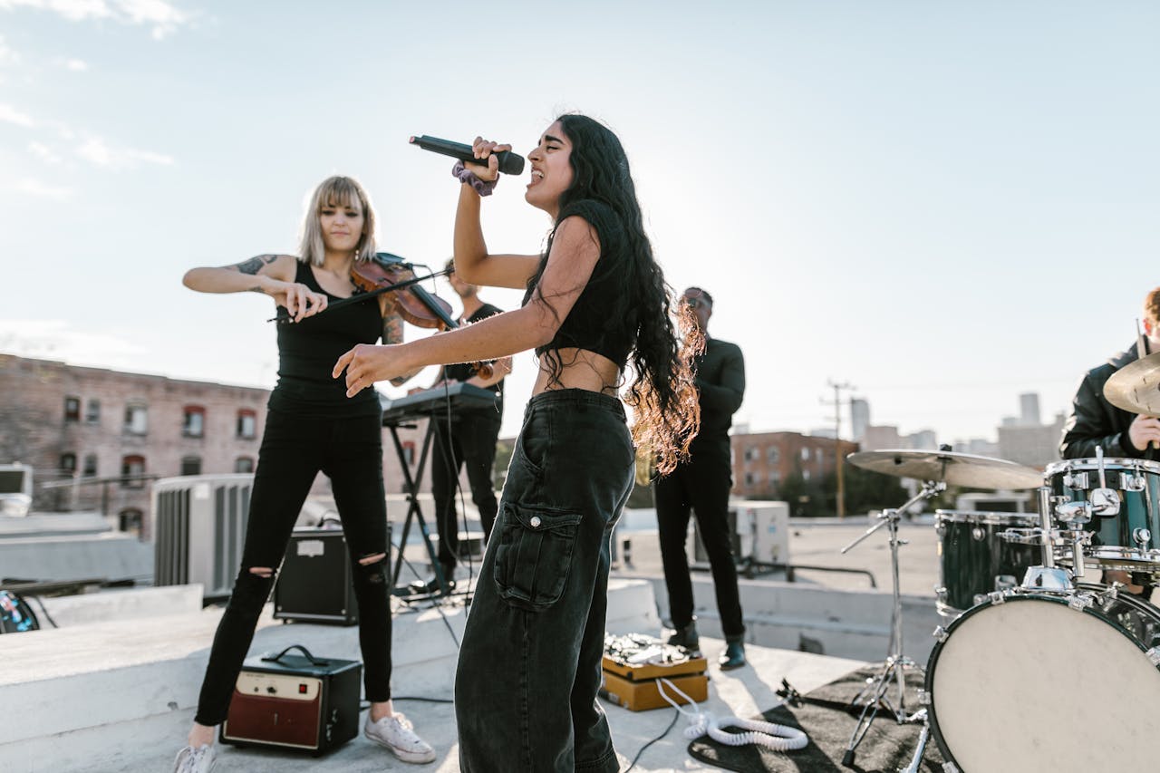 Energetic rooftop performance featuring musicians with instruments on a sunny day.